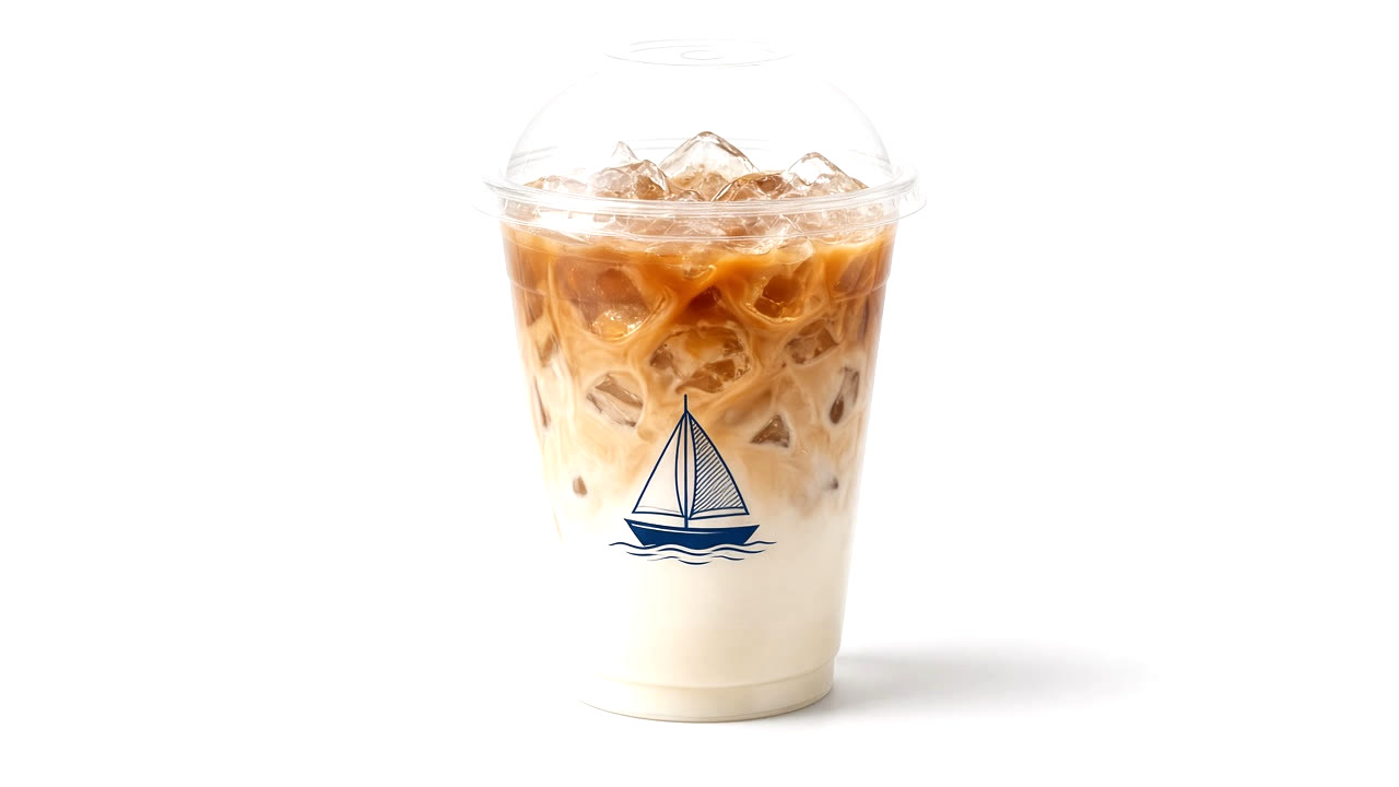 Iced latte in a clear Ninth Harbor cup with a dome lid